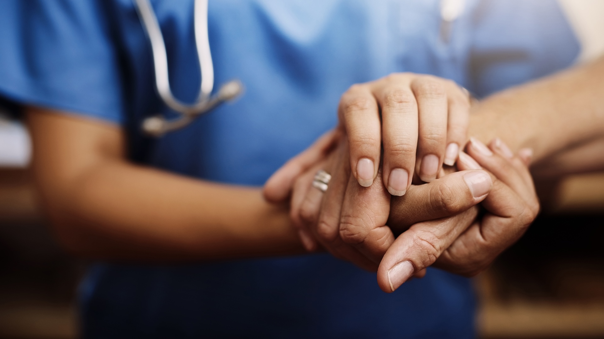 Closeup, doctor holding hands with senior woman and cancer care or support. Healthcare or trust, empathy or compassion and female caregiver or nurse holding elderly person hand for hope and kindness.
