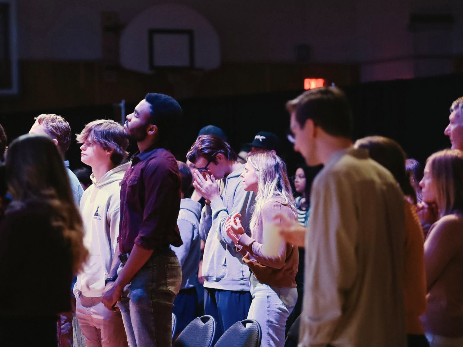 Members of a Covenant church plant worship together in a school gymnasium.